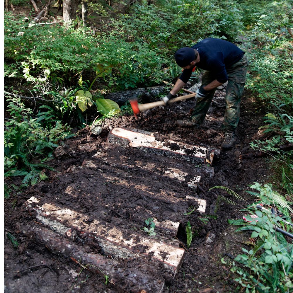 Alexis works on section of trail corduroy